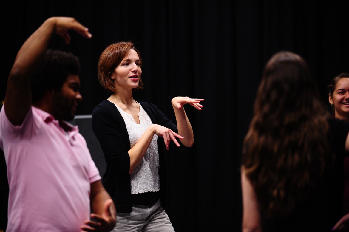 Hesston College theatre director Laura Kraybill leads an acting class through a warmup exercise.