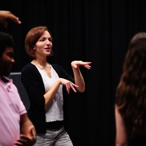 Hesston College theatre director Laura Kraybill leads an acting class through a warmup exercise.