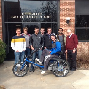 Hesston College Physics II students display the solar powered personal activities vehicle they built as a class project during the spring 2014 semester.