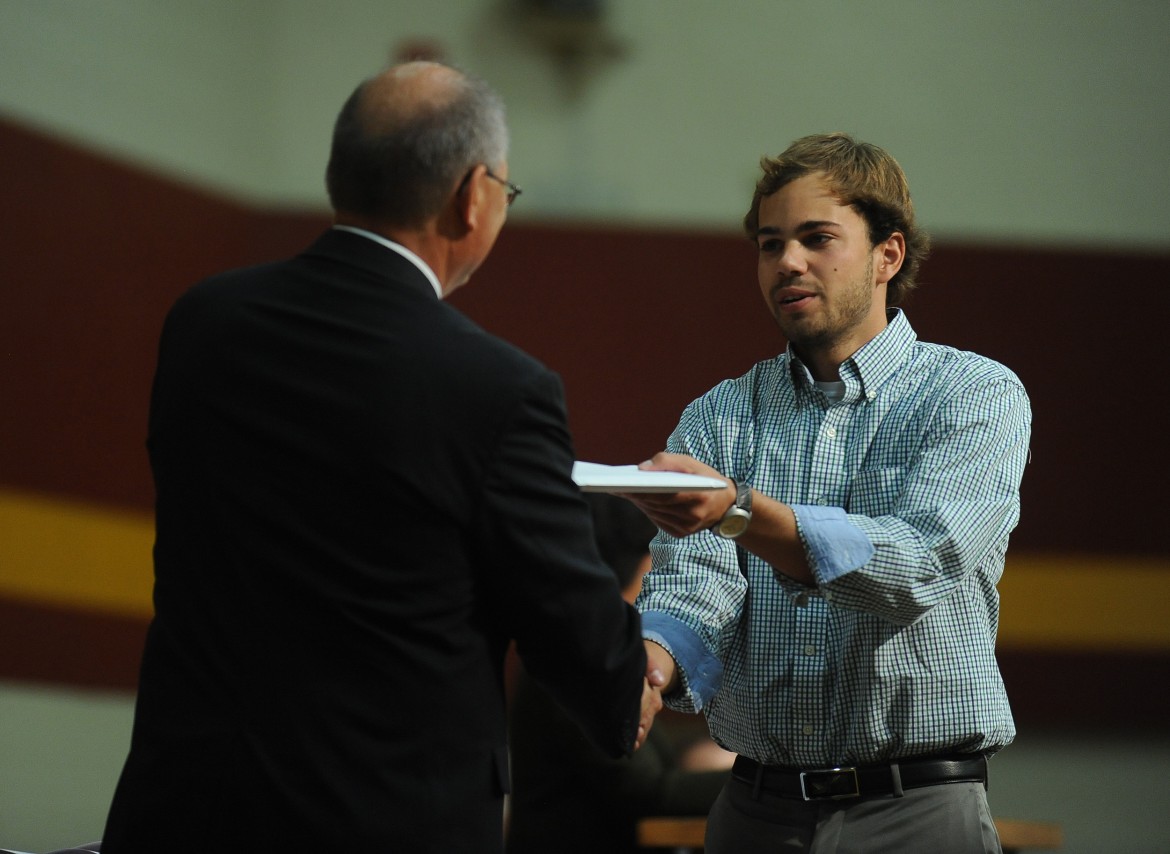 Mitchell Martin (Milford, Neb.), receives his Hesston College diploma from President Howard Keim.