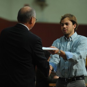 Mitchell Martin (Milford, Neb.), receives his Hesston College diploma from President Howard Keim.