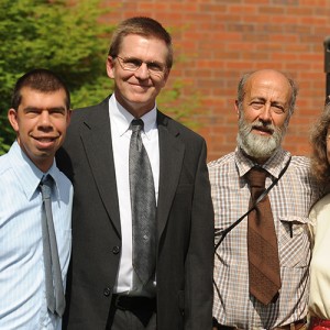 Simon Zehr (left) celebrates his graduation with his academic advisor Russ Gaeddert (second from left) and his parents Dennis Zehr and Ellen Davis-Zehr.