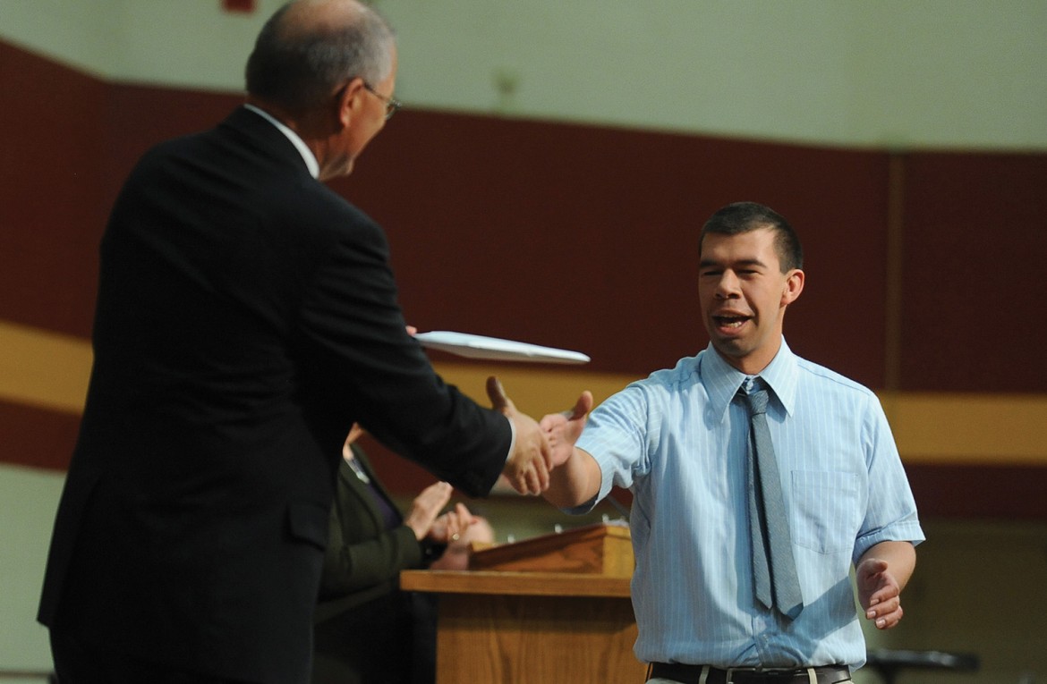 Simon Zehr receives his diploma from President Howard Keim