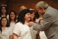 Kristal Potter receives her nursing pin from nursing faculty member Gregg Schroeder.