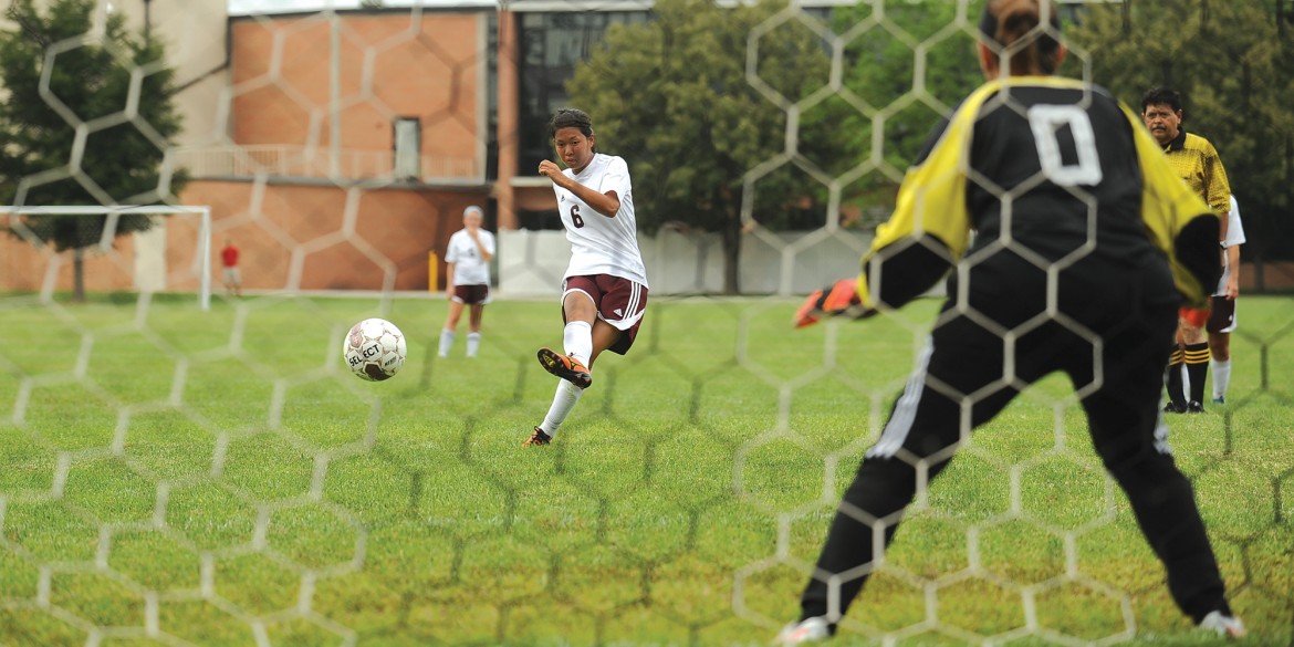 Machi Kanematsu scores a goal on a penalty kick for Hesston College.