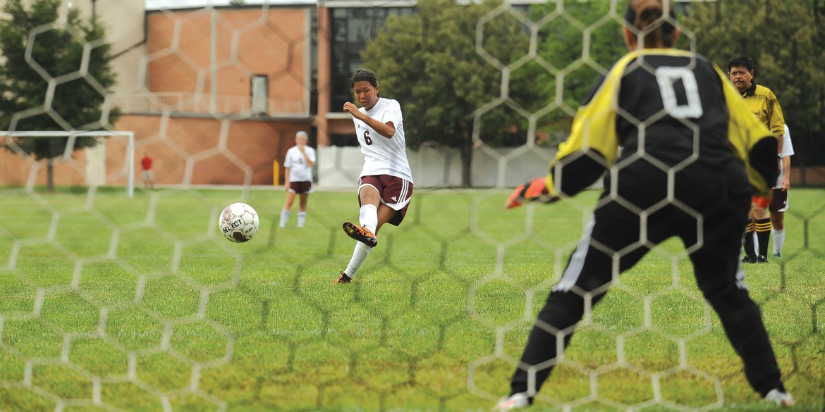 Machi Kanematsu scores a goal on a penalty kick for Hesston College.