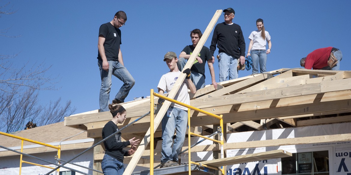 A group of Hesston College students and other volunteers work on the roof of a house in Pilger, Neb., during the college's spring break.