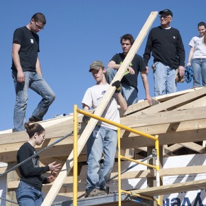 A group of Hesston College students and other volunteers work on the roof of a house in Pilger, Neb., during the college's spring break.