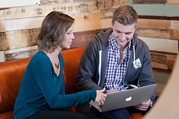 Roby Miller discusses strategic planning with Courtney Henecke, Telepharm operations manager. Photo by Jodi Gehman, Gehman Photography