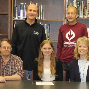 Renee Buckwalter signs a letter of intent to run cross country for Hesston College.