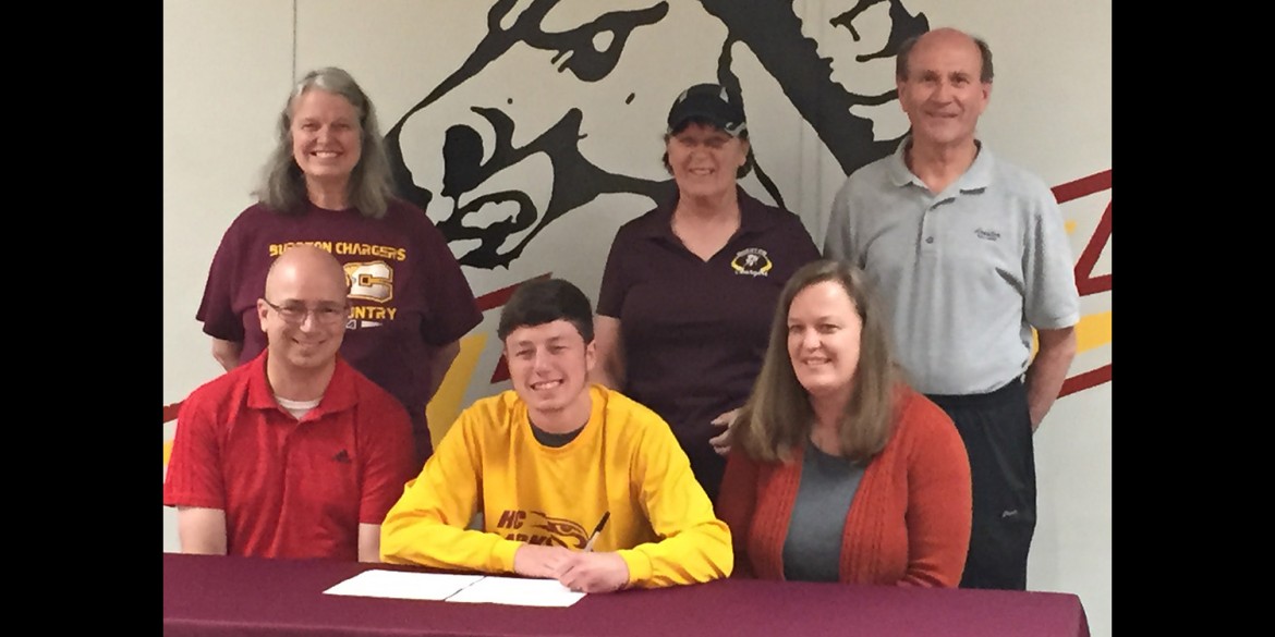 Collin Leonard signs a letter of intent to run cross country for Hesston College.