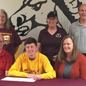 Collin Leonard signs a letter of intent to run cross country for Hesston College.