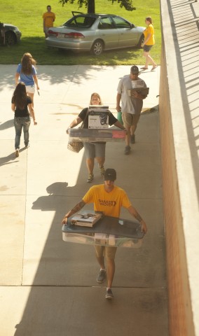 Shaker and Mover Cody Halvorson  (Temple, Texas) moves a fellow student's belongings into the dorms.