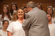 Lea Ulrich ’15 (Hesston, Kan.) recieves her nursing pin from faculty member Gregg Schroeder ’86.