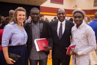 Alpha Mavungu Kivuvu is congratulated by education instructor Marissa King ’05, social science instructor and artist in residence Tony Brown and Rince Longo Kabondo.