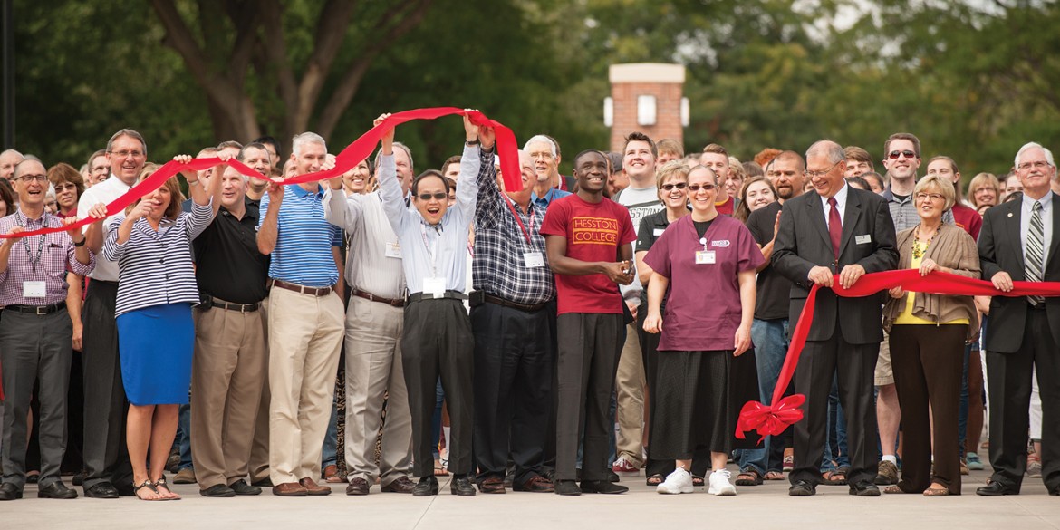 College and City of Hesston officials participate in the ribbon cutting for the college’s new campus entry Sept. 25.