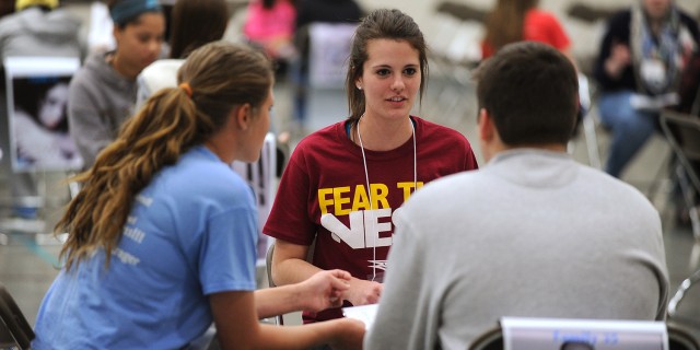 Freshman Vanessa Steckly (Milford, Neb.) makes plans with her family group at the start of the poverty simulation.