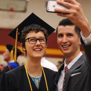 Graduate RaeLee Hightower (Tulsa, Okla.) takes a post-graduation selfie with English faculty member Donovan Tann.