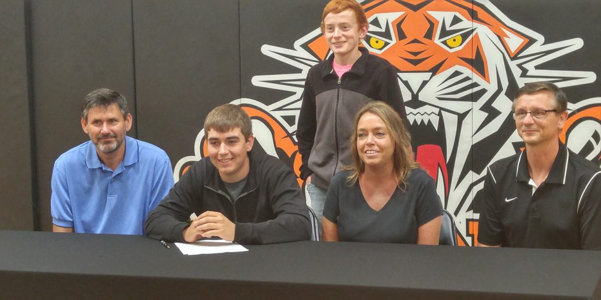 Sam Sowers signs a letter of intent to play golf at Hesston College.