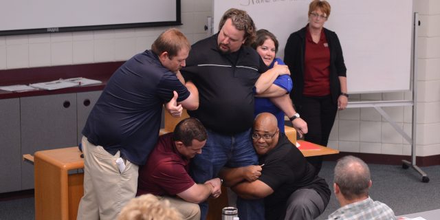 A group of higher education representatives present on their take away points from Harvey County ALICE training on July 26. 