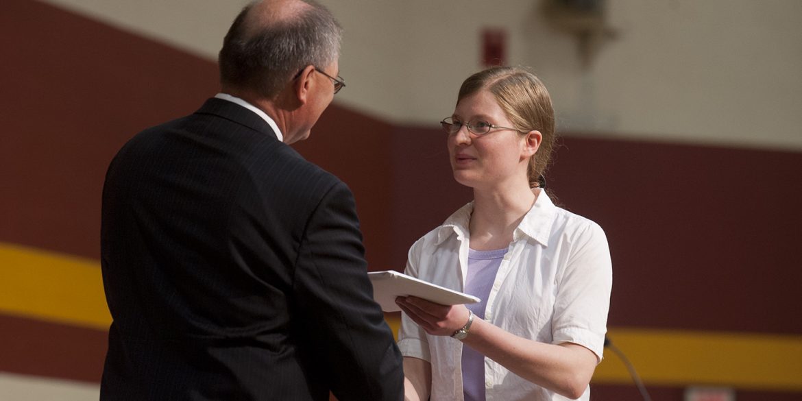Sheralynn Neff receives her Hesston College diploma from President Howard Keim during Commencement in May 2011.