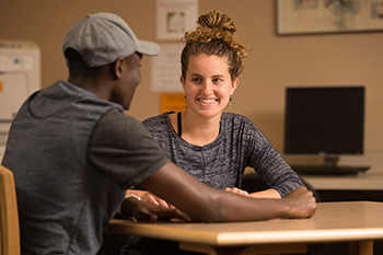 Adrienne Derstine serves as a Writing Fellow peer tutor and helps guide a student through the writing process.