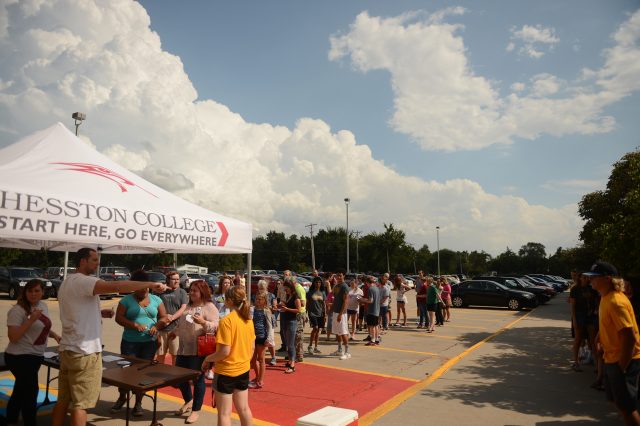 Students and parents line up to outside of Bontrager Student Center to check in for a new year with admissions counselors Allie Shoup and Michael Smalley.