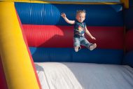 Future Lark Ty Martin, son of Steve ’04 and Kristi Martin, goes airborne on an inflatable slide at the family festival.