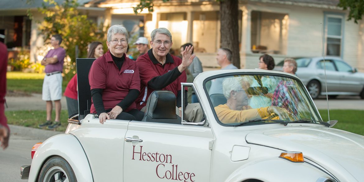 Interim President Ben Sprunger and his wife, Sue, ride in the community-wide Homecoming parade.