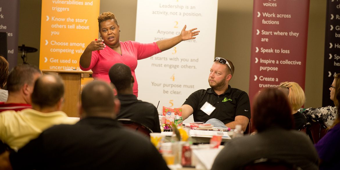 Environmental science professor Marelby Mosquera presents to a group of 30 Excel Industries employees during a leadership training program hosted and presented by Hesston College.