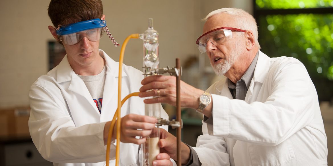 Chemistry prof Jim Yoder works with a student in the organic chemistry lab.