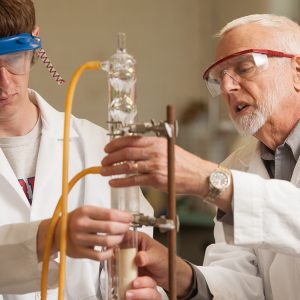 Chemistry prof Jim Yoder works with a student in the organic chemistry lab.