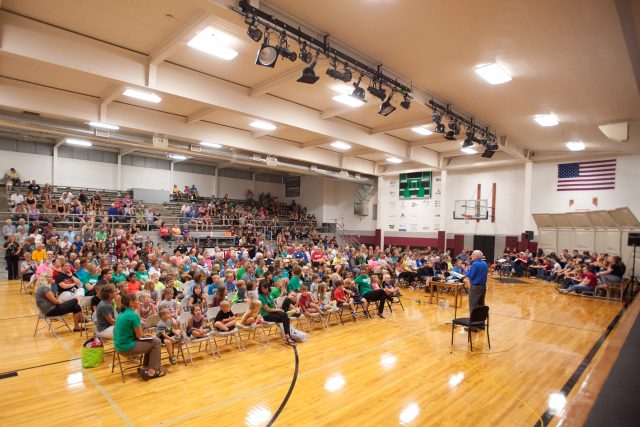 Hesston College chemistry professor Dr. Jim Yoder and the Bel Canto Singers present an eclipse program to a crowd of about 450 at Shickley (Neb.) Public School. Groups involved in the day included Hesston College science, math and education students, faculty and staff, Shickley Public School students in grades PreK-12, faculty and staff, Hesston College alumni and friends, and members of the community of Shickley and Salem Mennonite Church (Shickley).