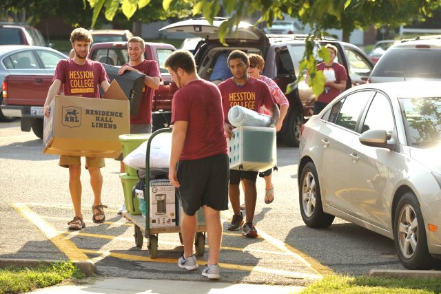 Hesston College resident assistants (clockwise from front) Garrett Roth (Hesston, Kan.), Angus Siemens (Newton, Kan.), Curtis Oesch (Caldwell, Idaho) and Keegan Cook (Whitewater, Kan.) help a new student move into the dorms during one of the move in times throughout the week leading up to Opening Weekend.