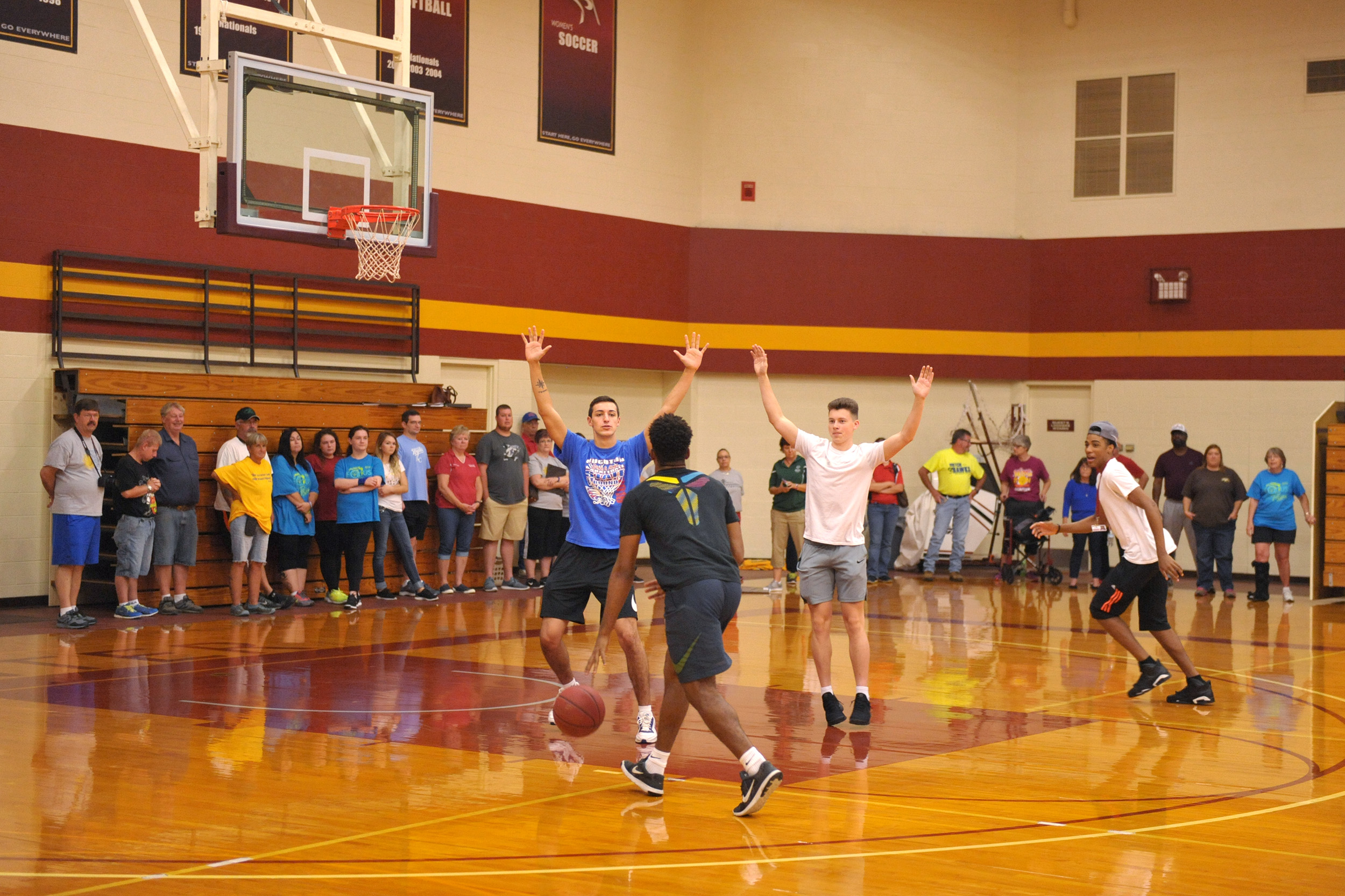 Hesston College men's basketball players demonstrate drills at a clinic for prospective Special Olympics coaches.