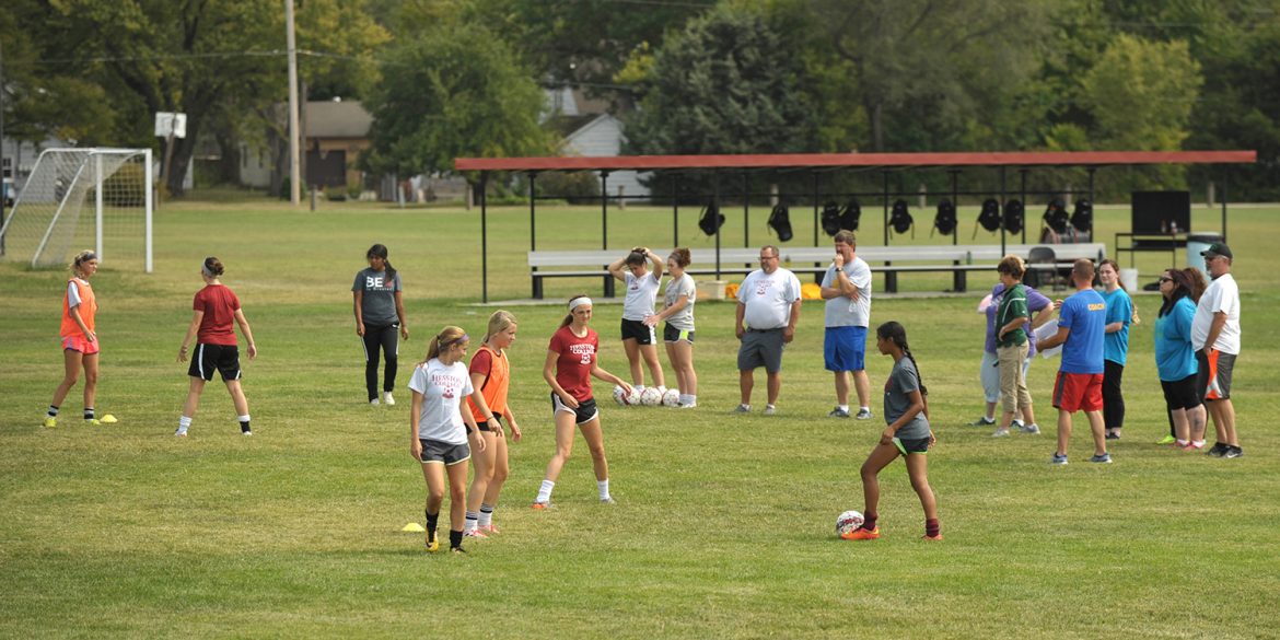 Hesston College women's soccer players demonstrate drills at a clinic for prospective Special Olympics coaches.