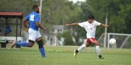 Hesston College men's soccer player Javier Reyna shoots in a 2017 season match.