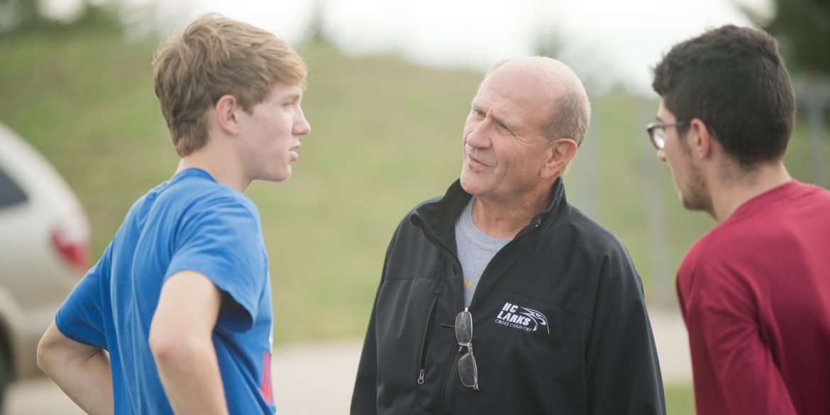 Coach Gerry Sieber visits with freshmen Brandon Kirby (Potwin, Kan.) and Tobias Belknap (Inman, Kan.) at practice.