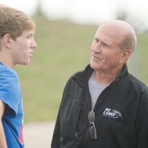 Coach Gerry Sieber visits with freshmen Brandon Kirby (Potwin, Kan.) and Tobias Belknap (Inman, Kan.) at practice.