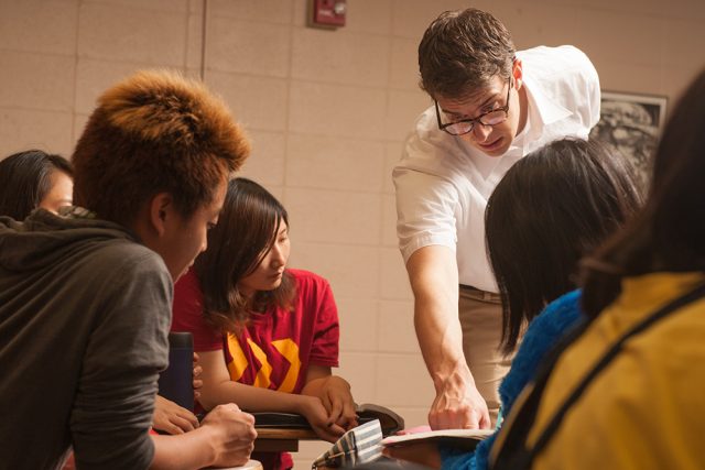 English as a Second Language professor André Swartley ’99 works with students in class. 