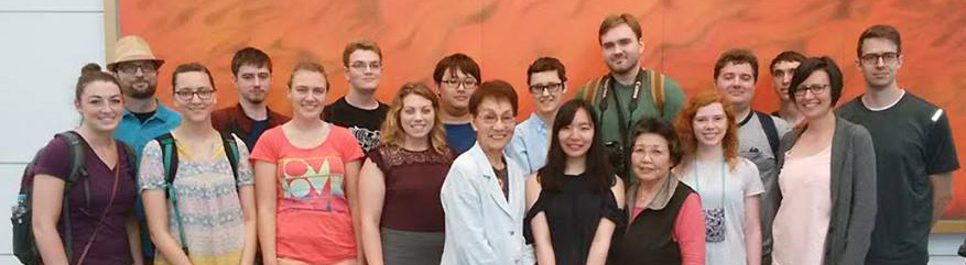 The May Term in Japan group take a photo with a survivor of the Hiroshima atomic bomb (center) after hearing her story.