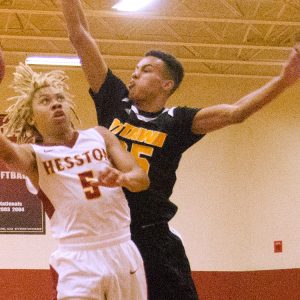 Coye Campbell drives the lane in a Hesston College game with Ottawa University JV.