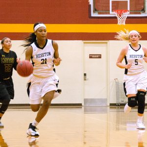 Milaya Bray brings the ball up the court for Hesston College.