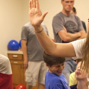 Freshman Cassidy King high fives a WOW participant during a game.