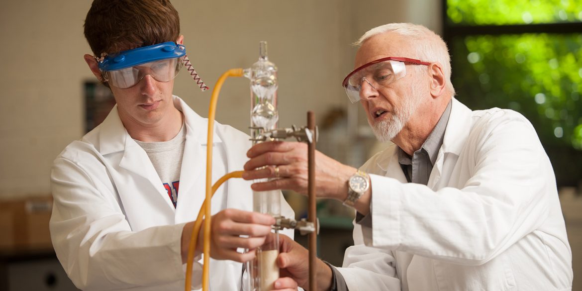 Jim Yoder works with organic chemistry student Jared Hague in spring 2016