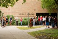 Students walk the avenue of flags.