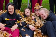 Student athletes raking leaves