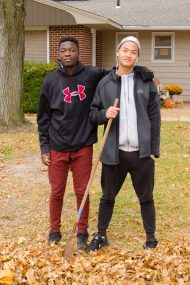 Student athletes raking leaves