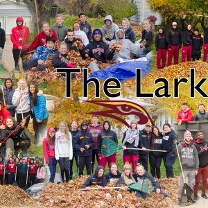 Student athletes and coaches rake leaves as a service project - The Lark Way