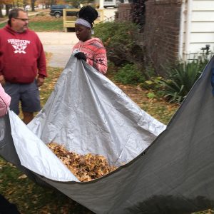 Members of the women’s soccer team move a load of leaves during a Saturday Athletic Department service project where all student-athletes and coaches raked leaves in the community. Photo by Jaden Hostetter ’19.